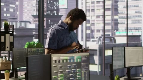 Man walking with tablet in office, fixing coding issues Stock Footage 318160984