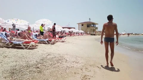 A man walking in the tel aviv's beach Stock Footage 145867586
