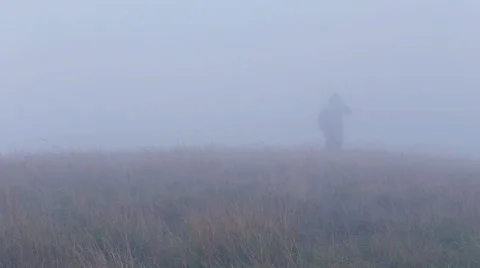 Man walking in terrible, windy and foggy weather Stock Footage 45434294