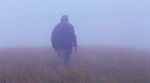 Man walking in terrible, windy and foggy weather Stock Footage 45434510