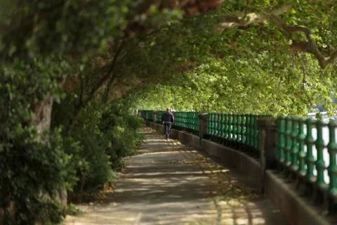 Man walking by the Thames Stock Photos