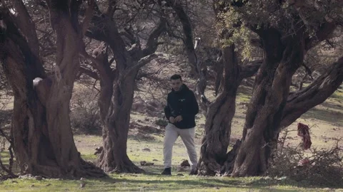 Man Walking Through Ancient Argan Tree Forest Ait Isafn Mountains Morocco Stock Footage 332773161