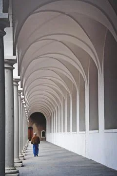 A man walking through the archade. Stock Photos