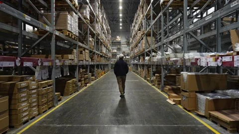 Man walking through a big warehouse Stock Footage 241733485