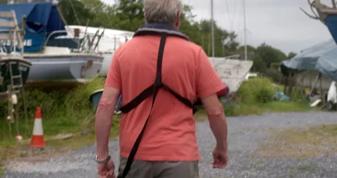 Man walking through boat yard Stock Footage 227134346
