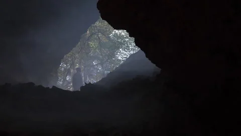 Man Walking Through Cave Rocky Mountain Landscape Stock Footage 264666318