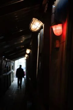 Man is walking through dark underground Stock Photos