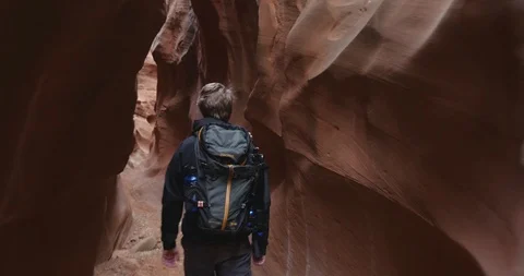 Man walking through desert canyon in Utah Stock Footage 102293191