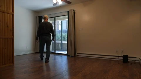 A man walking through an empty apartment or condo Stock Footage 141322444
