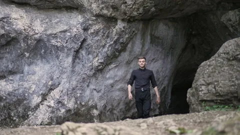 A man is walking through a gorge Hiking in the mountains Stock Footage 158045867