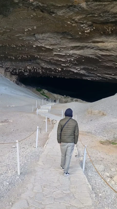 Man walking through the legendary Cueva del Milodón in Patagonia, Chile 動画素材 340946609