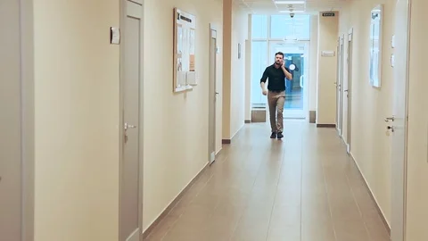 Man walking through a long corridor Video stock 73470207