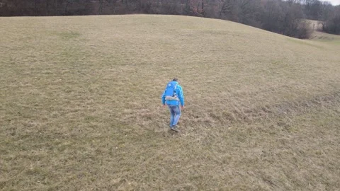 Man walking through meadow 2021 jan 25 002 Stock Footage 147375817