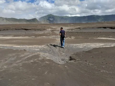 A man walking through Mount bromo an active volcano Stock Photos