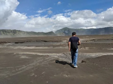 A man walking through Mount bromo an active volcano Stock Photos