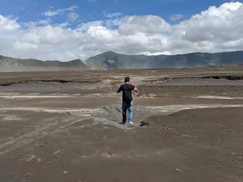 A man walking through Mount bromo an active volcano Stock Photos