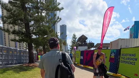 Man Walking Through Outdoor Event Entrance in Surfers Paradise Stock Footage 344941716