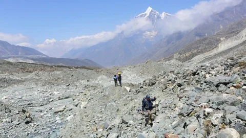 Man walking through the rocks in mountainous region Stock Footage 77450366