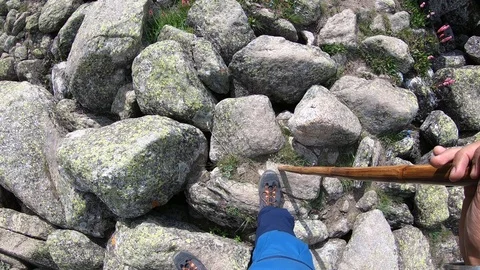 Man Walking through the rocky mountain terrain. Stock Footage 124942131