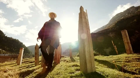 Man walking through scenery at sunset 스톡 동영상 42944969