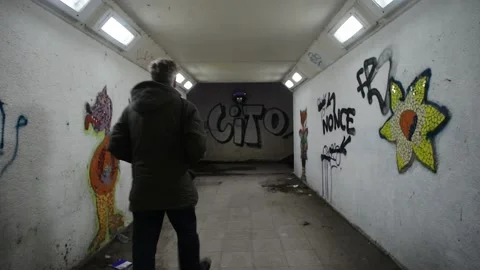 Man walking through underpass tunnel under road at night leeds united kingdom Stock Footage 171481272