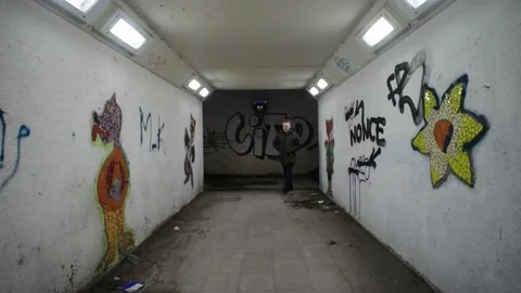 Man walking through underpass tunnel under road at night leeds united kingdom Stock Footage 171481346