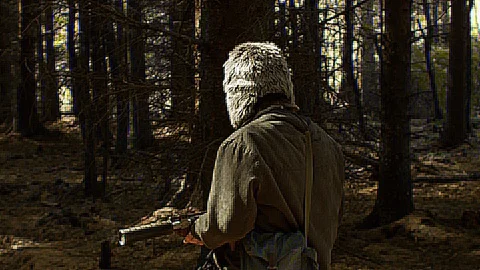 A man walking through the woods with a makeshift gun Video stock 89407558