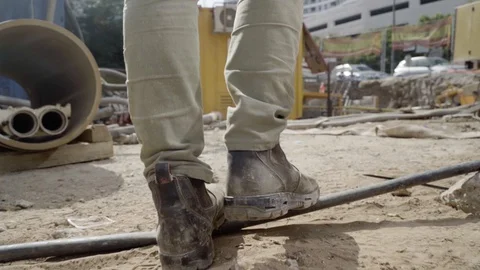 Man walking through working industrial site. Follow shot to a male worker feet Video stock 128883638