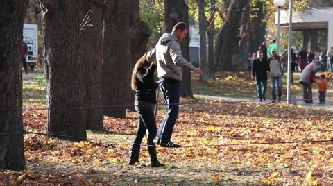 Man walking on a tightrope Stock Footage 45990101