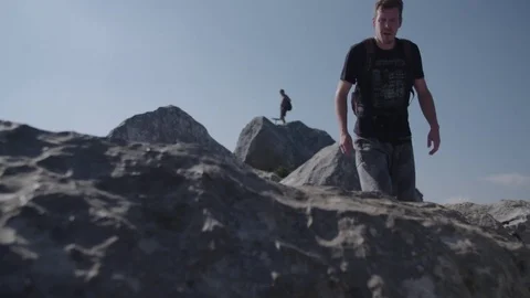 Man walking on a top of the mountain Видео 76739778