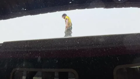 Man Walking on Top of Passenger Train During Rain at Bangladesh Railway Station Stock Footage 341641013