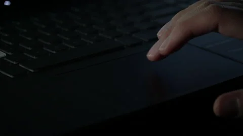 Man walking on touch computer in front of laptop in dark room Video stock 237374412