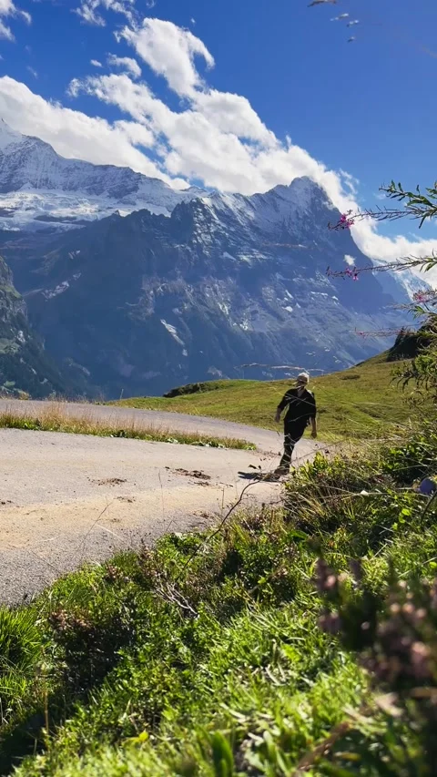 Man Walking Toward Camera on Mountain Track Stock Footage 329250582