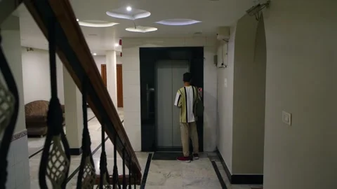 Man Walking Toward Elevator Indoors 库存影片 337775868