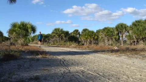 Man Walking Towards Camera on Florida Hiking Trail Stock Footage 171949111