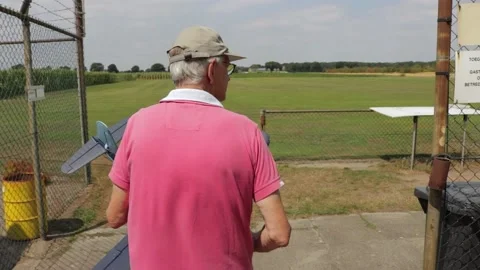 Man Walking Towards Flying Zone With A Model Plane At A Flight Club Stock Footage 130676661