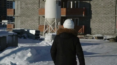 Man is walking towards the house under construction Stock Footage 82145283