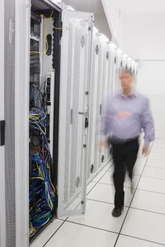 Man walking towards open server tower Stock Photos