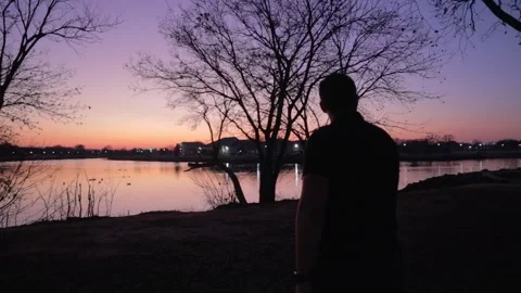 Man Walking towards Sunset Stock Footage 272286308
