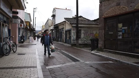 A man walking in the town of Mytilini  Stock Footage 116304786