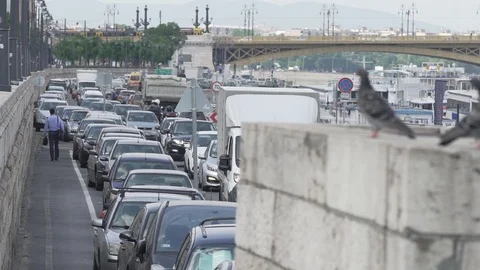 Man walking in the traffic jam, slow motion, stock video Stock Footage 90398120