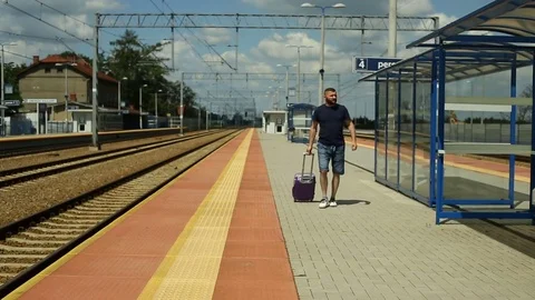 Man walking on the train station and checking time on smartphone Stock Footage 78656135