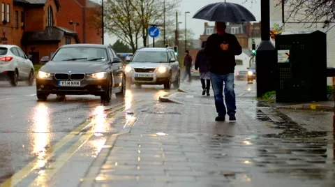Man walking with umbrella in rain and cars passing Video stock 44017339