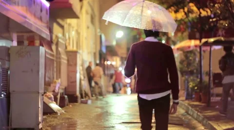 Man walking with an umbrella under rain Stock Footage 42093226