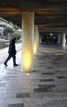 Man Walking Under Overpass Stock Photos