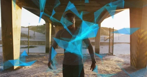 Man walking under overpass toward camera, starting tech particles circling Stock Footage 323479235