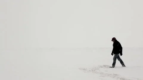 Man Walking Under a Snow Storm Stock Footage 162257109