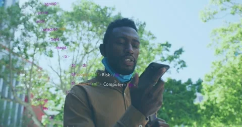 Man walking under trees, lifting smartphone to mouth, activating security code Stock Footage 329946786