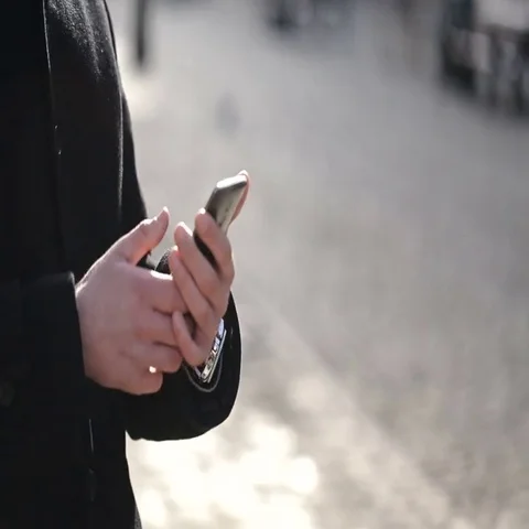 Man walking using mobile phone gps Stock Footage 69621384