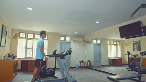 Man Walking Using Treadmill In Small Gym Room Stock Footage 162032750